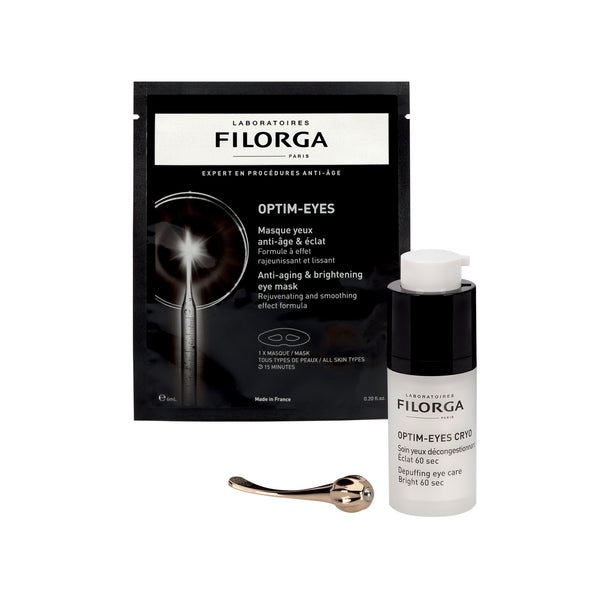 Laboratoires Filorga Optim-Eyes anti-aging eye mask set, featuring a black pouch, a clear bottle with a white cap, and a small metal spatula on a white background.